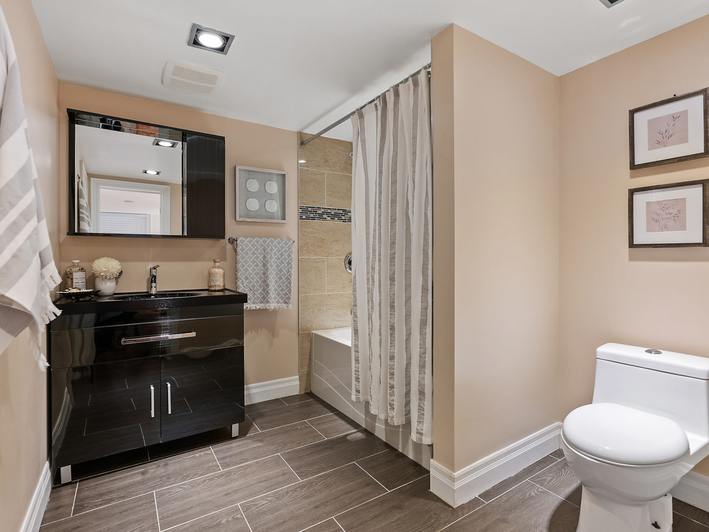 A big bathroom with a toilet, a sink, and a shower.