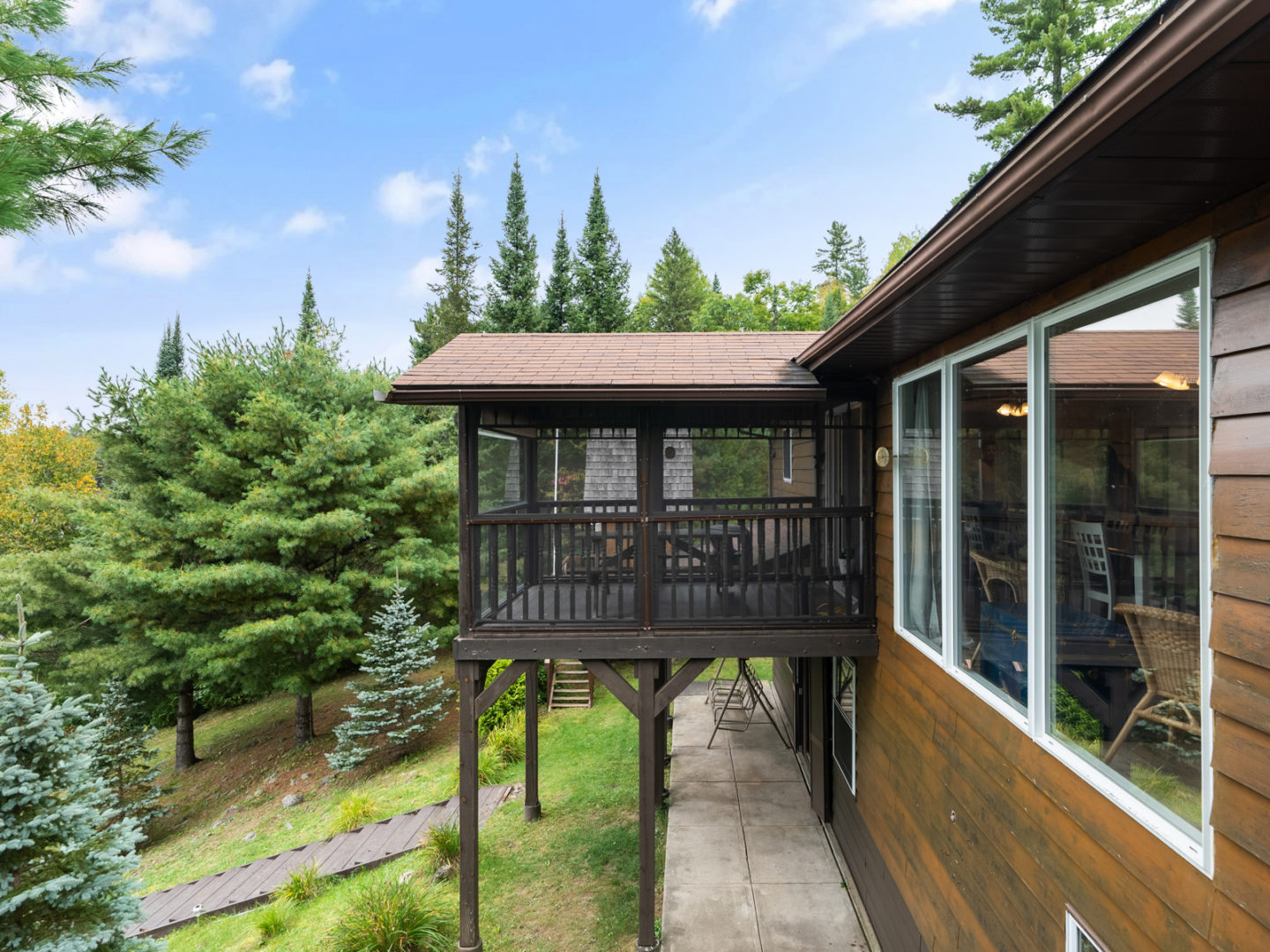 A screened-in patio area branching off the second level of a house.