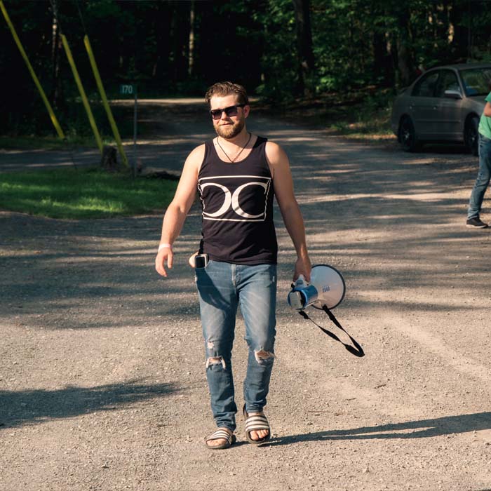 A young man carrying a megaphone