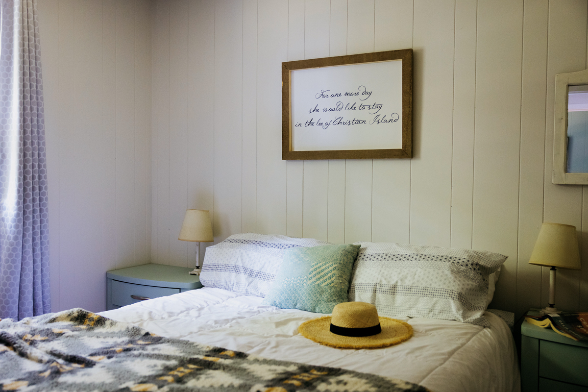 A bedroom interior with a framed song lyric from Gordon Lightfoot on the wall