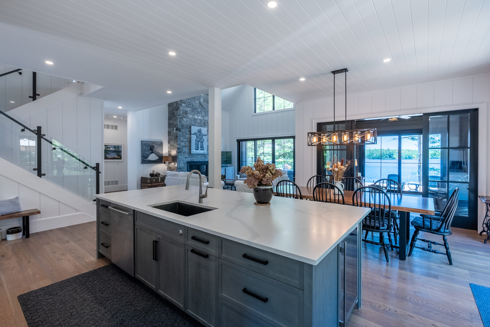 An open-concept kitchen and dining space with a big table beside a large island.