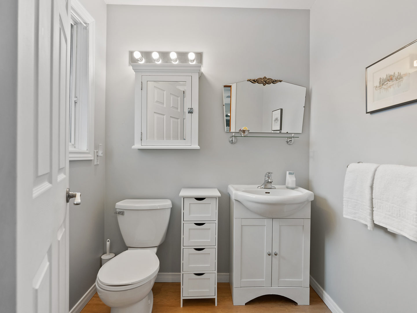 A small ensuite bathroom with a toilet and a sink.