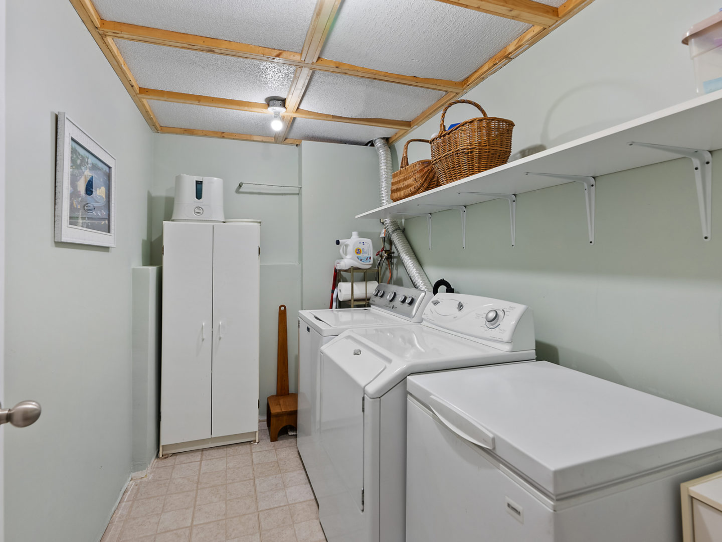 A small laundry area with a washing machine and a dryer.