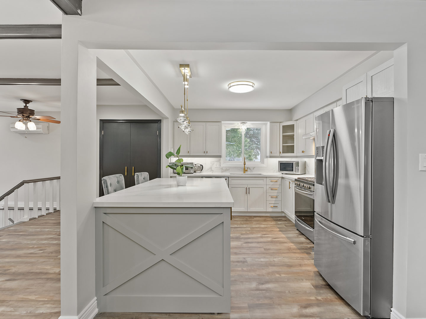 A bright, newly renovated kitchen with an island, lots of counter space, and updated appliances.