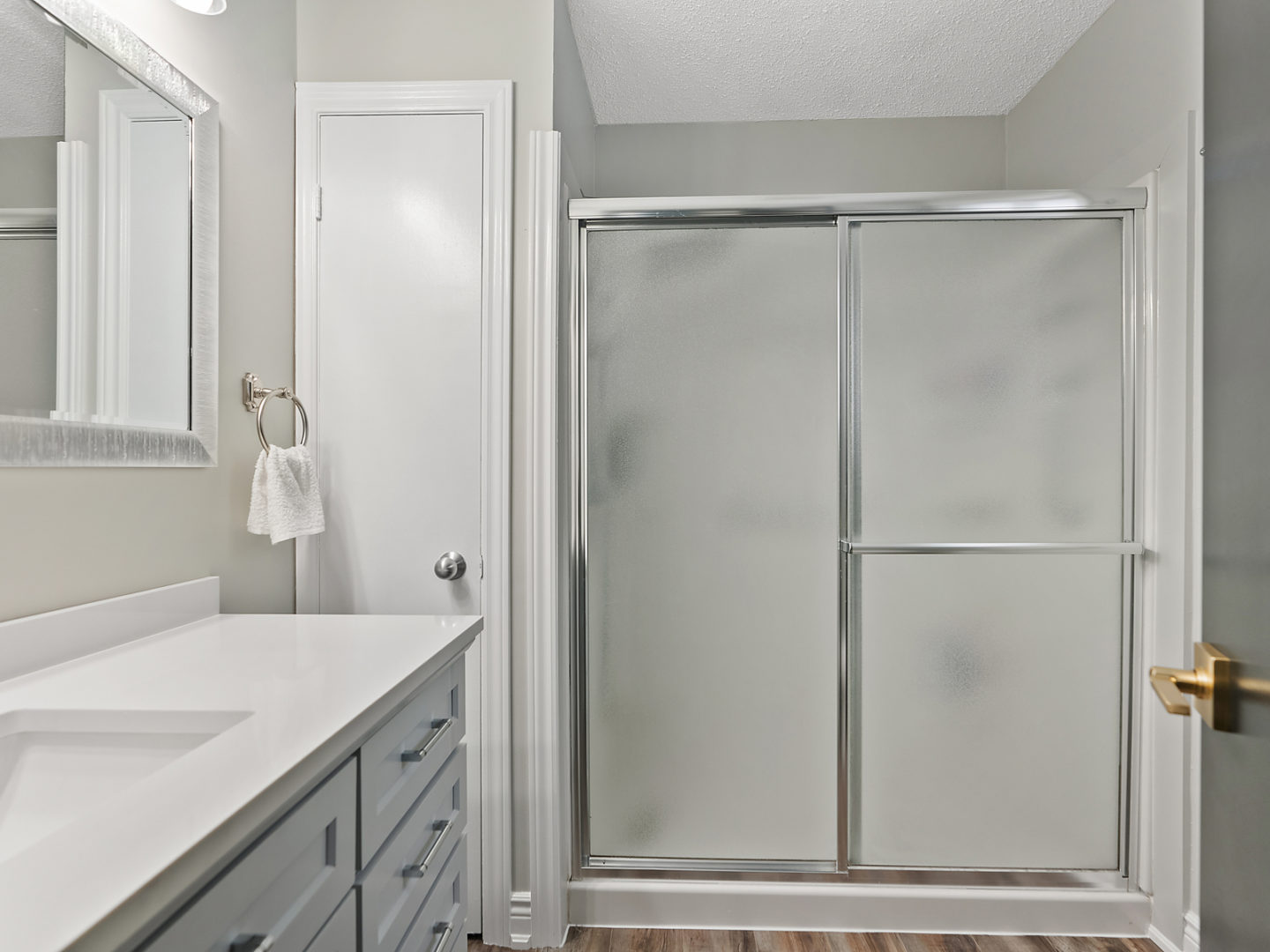 An ensuite bathroom with a sink and a shower.