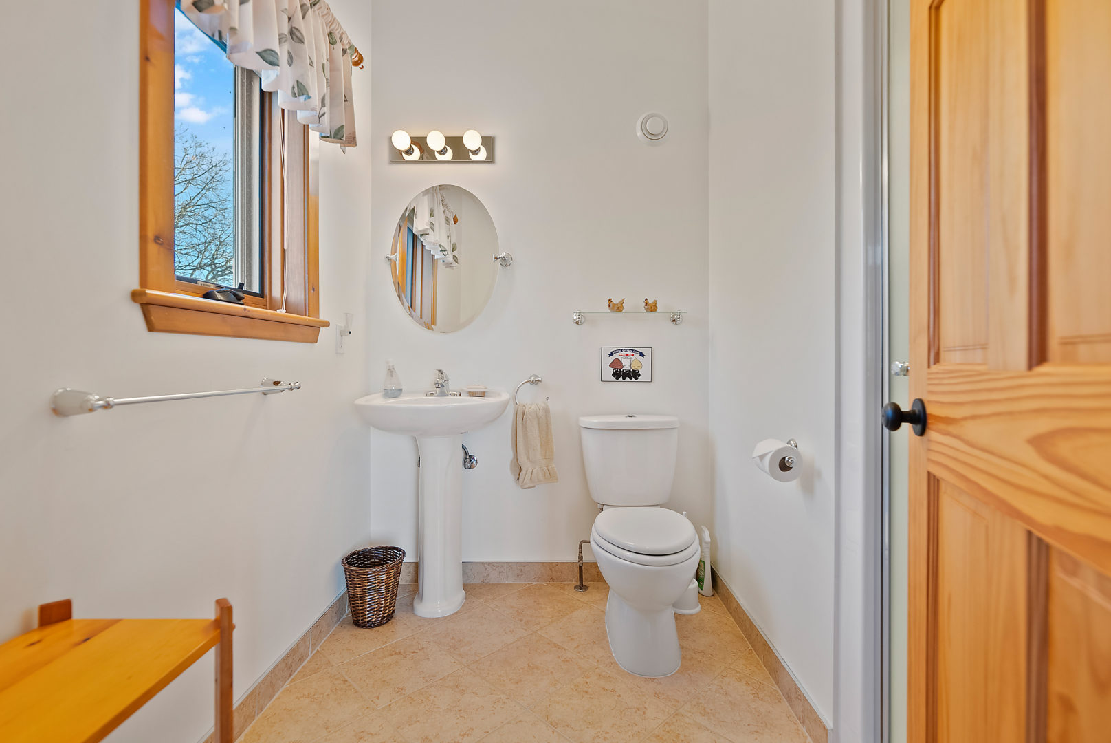 A small power room bathroom with a toilet and a sink.