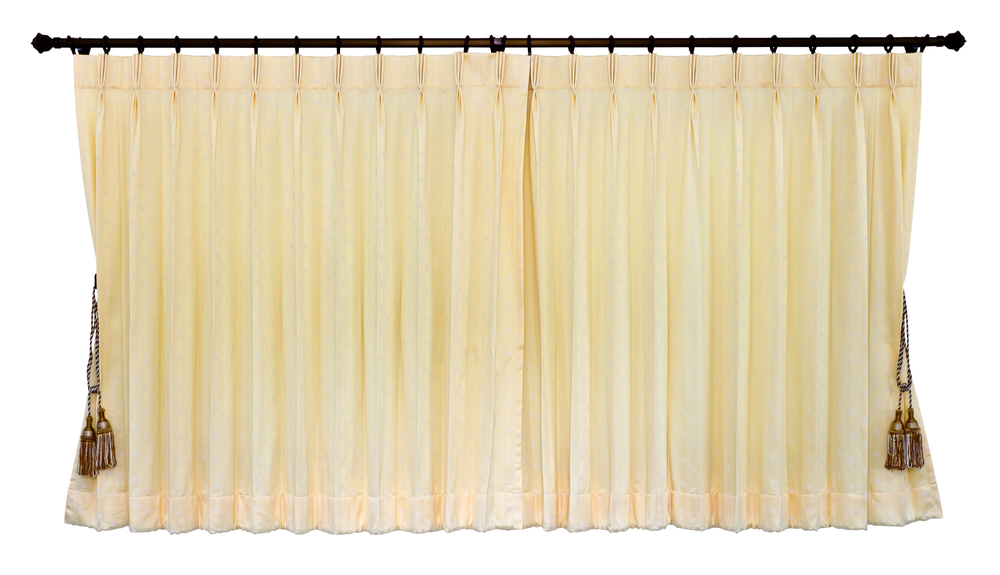 A close-up shot of yellow curtains closed