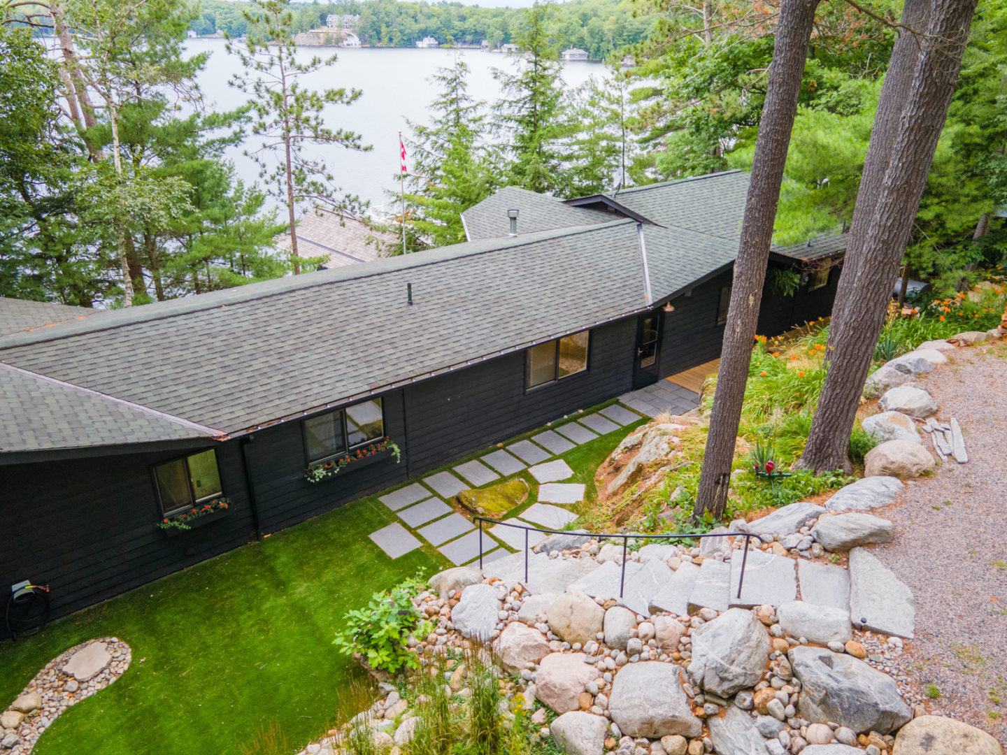 Steps down to the entrance of a large lakefront cottage.