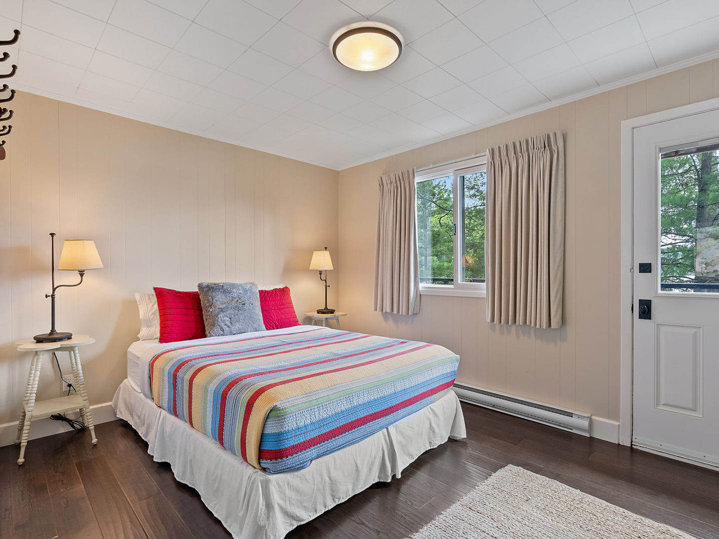 A bright bedroom with a bed and a window.