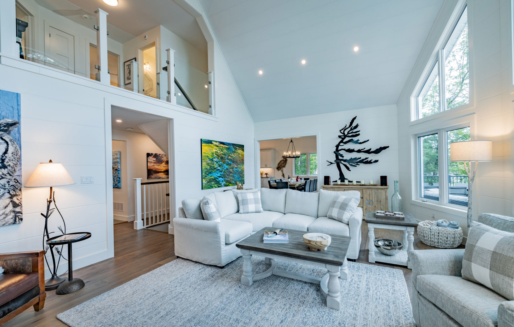 A large living area with high ceilings, a couch, and a coffee table.