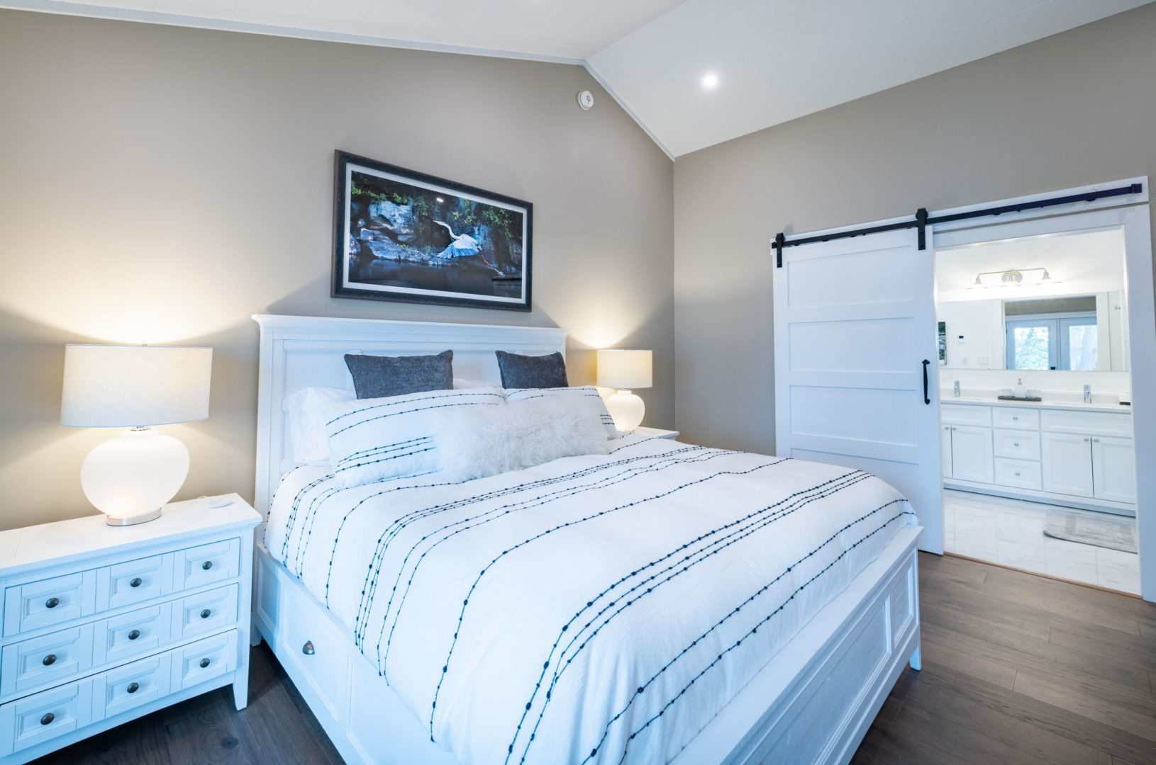 A spacious bedroom with a large bed and an en-suite bathroom.