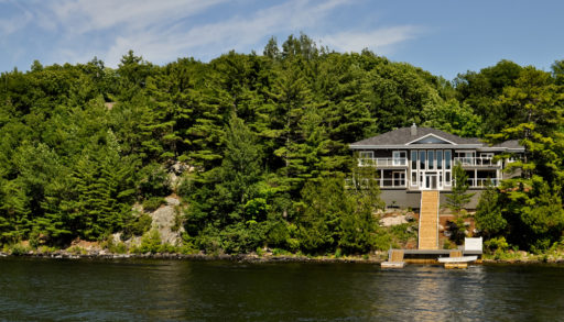 Cottage with a staircase to the dock on a lake