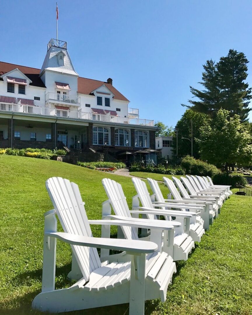 Outside Windermere House, muskoka chairs in the foreground