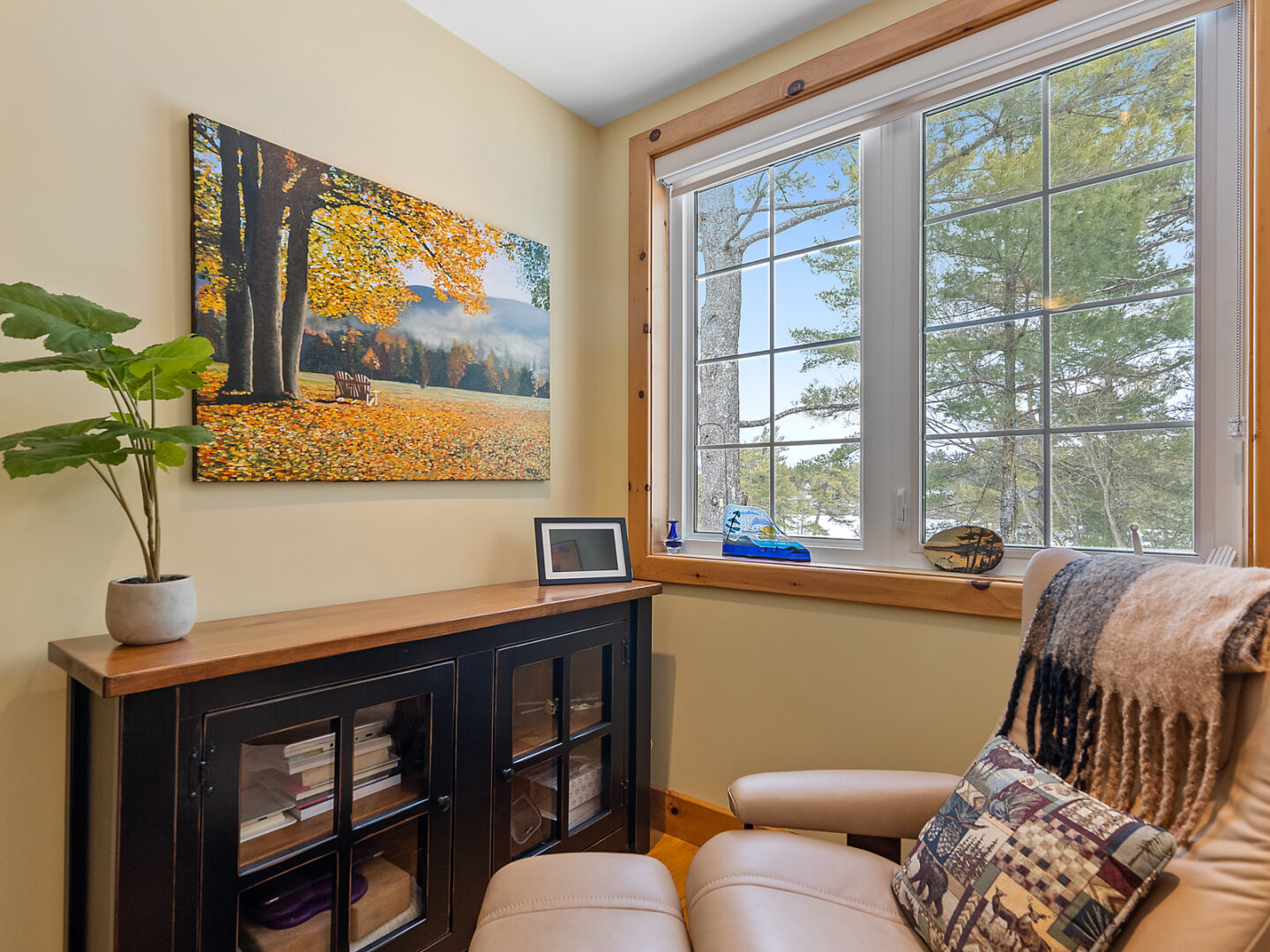 A cozy chair sitting in front of a window in a bedroom.