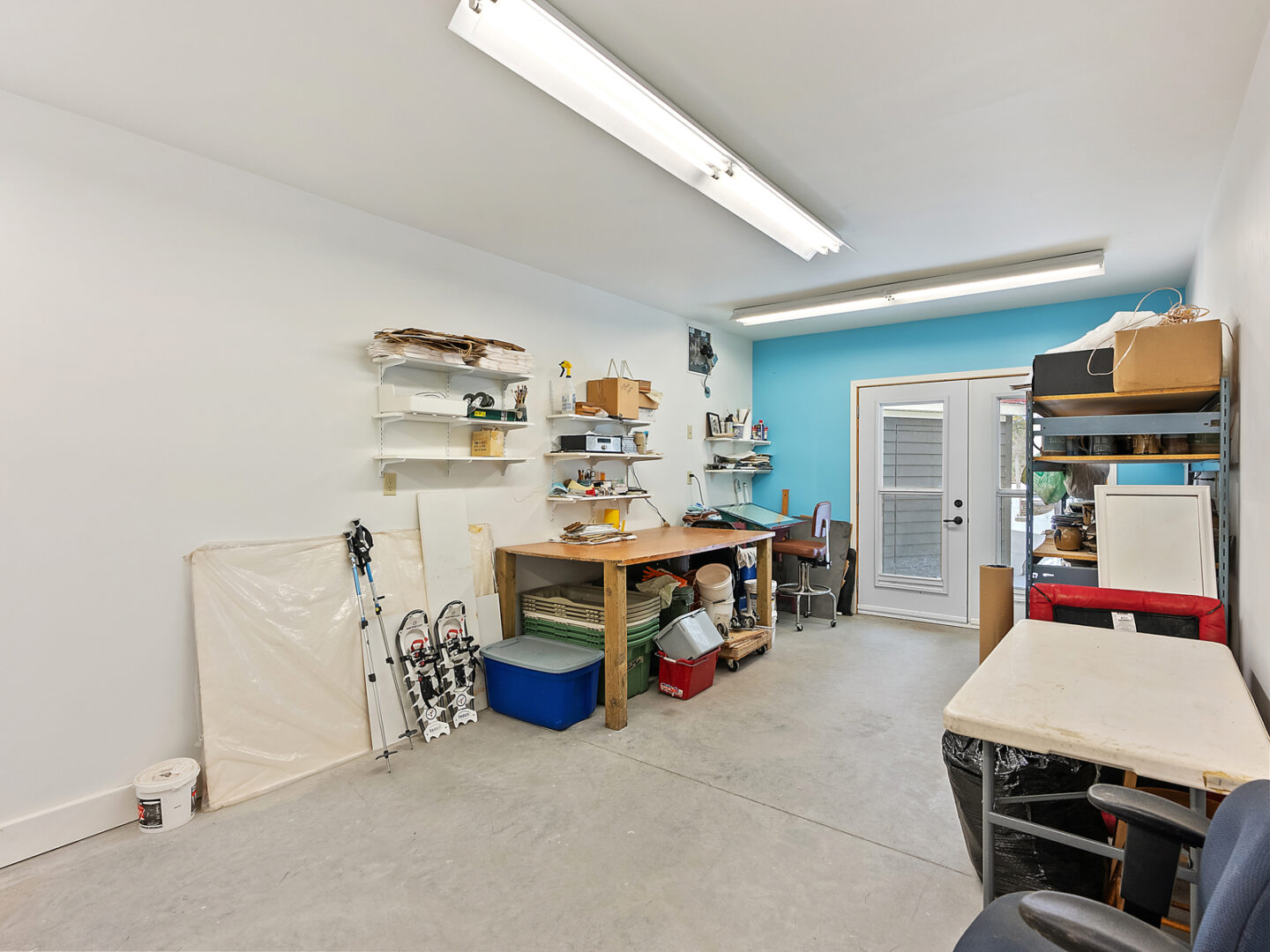 A garage workspace with worktables and equipment.