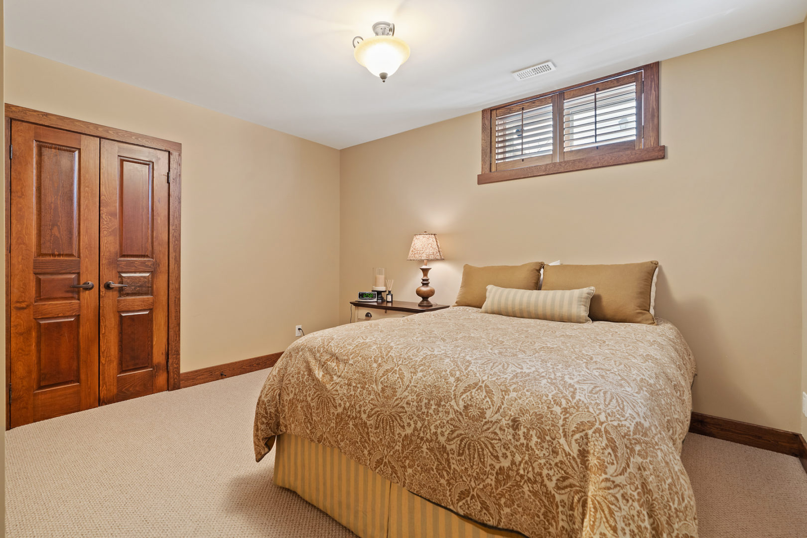 A basement bedroom with a large bed.
