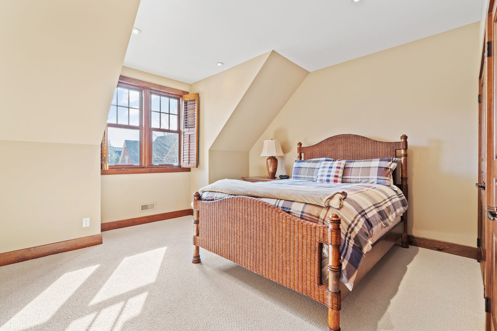 A bright bedroom with a large bed.