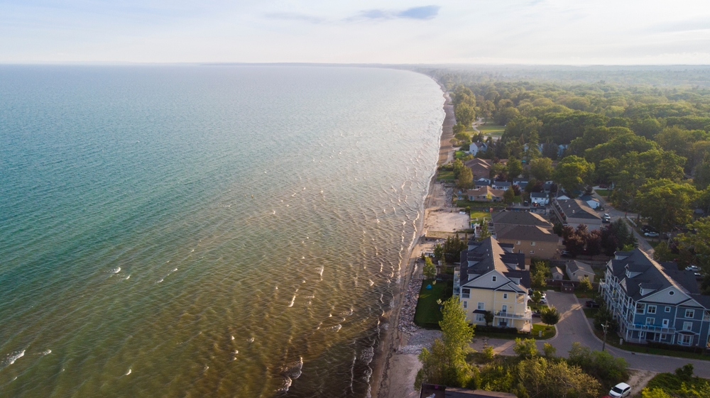Aerial view of Wasaga Beach, Canada with cottages along the beach close to shore. What sellers need to declare