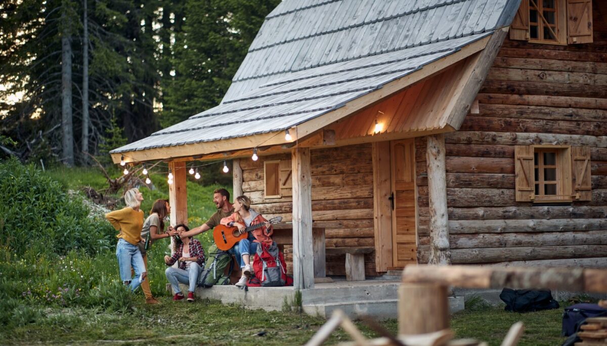 a group of friends on the porch of a cottage