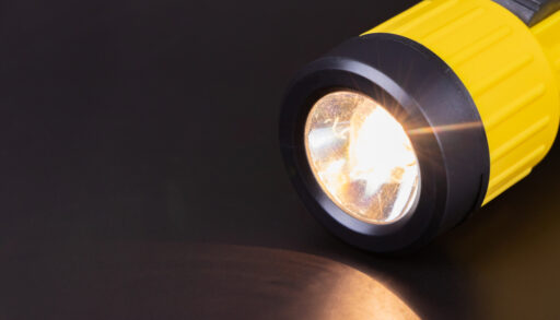 Lit yellow flashlight during a power outage