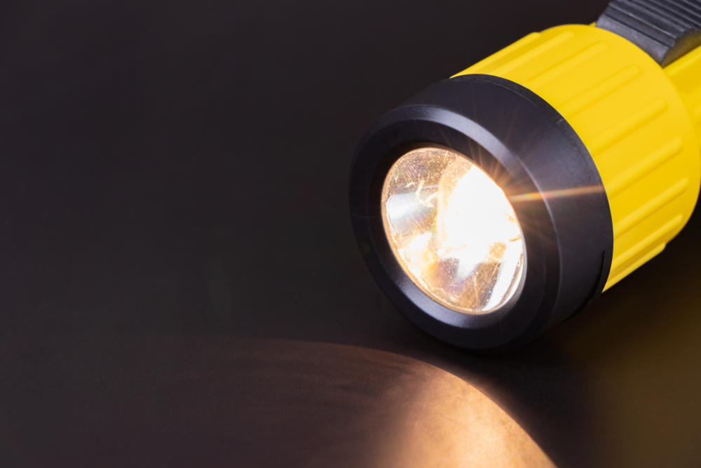 Lit yellow flashlight during a power outage