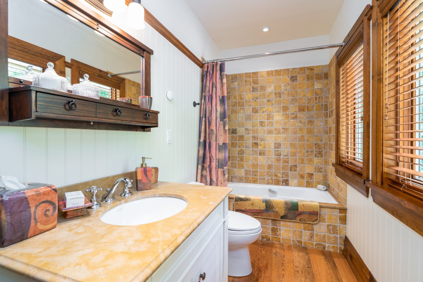 A small bathroom with a toilet, a sink, and a shower/tub combo.
