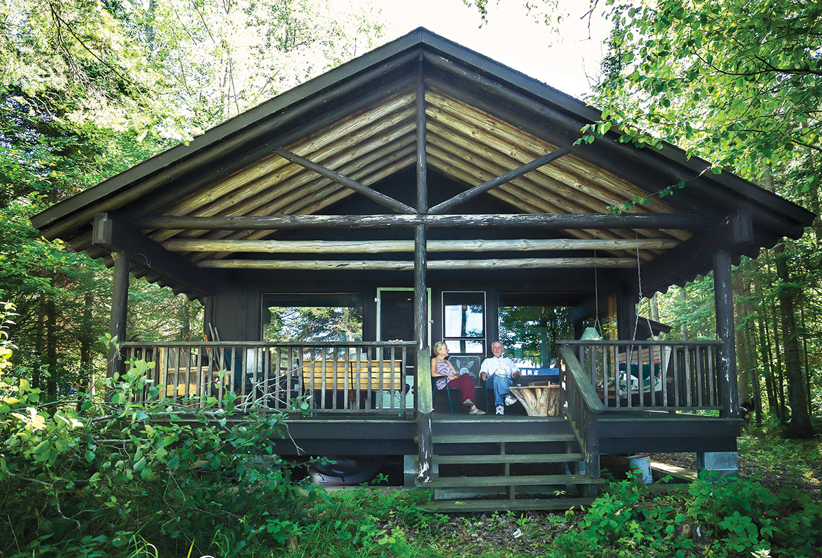 front of the log cabin cottage built by Albert including the porch