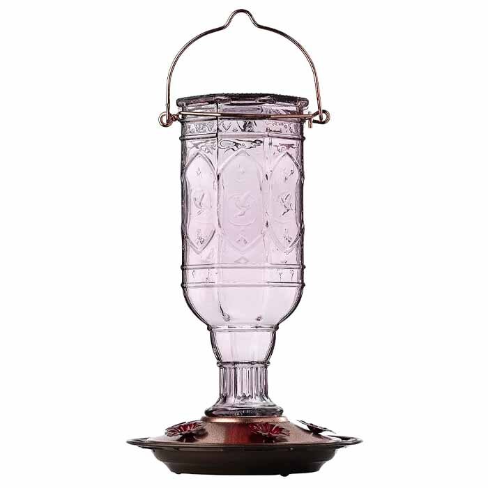 Antique looking hummingbird feeder made with pink glass and metal