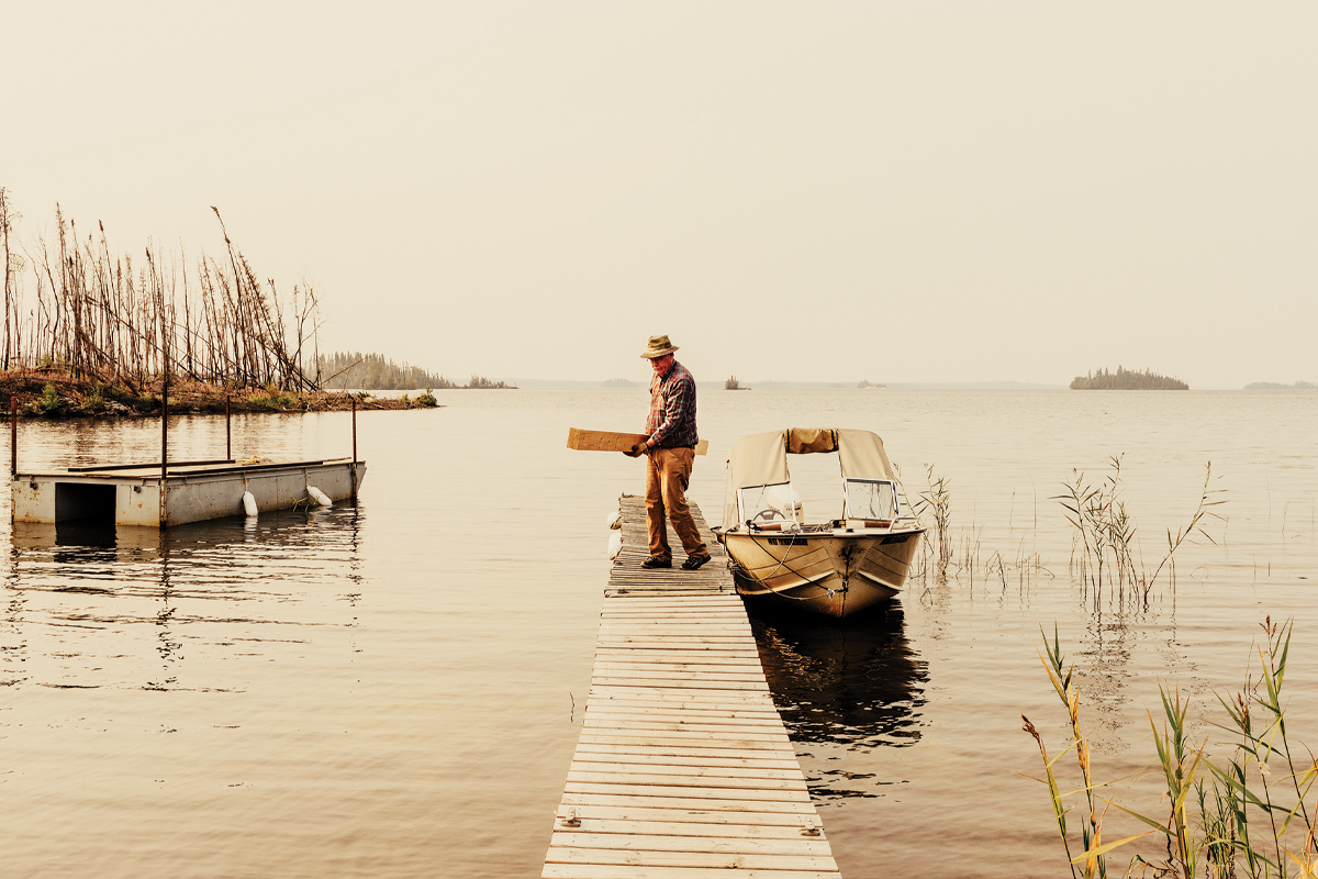 Eric Woodsworth carries building materials from family's boat
