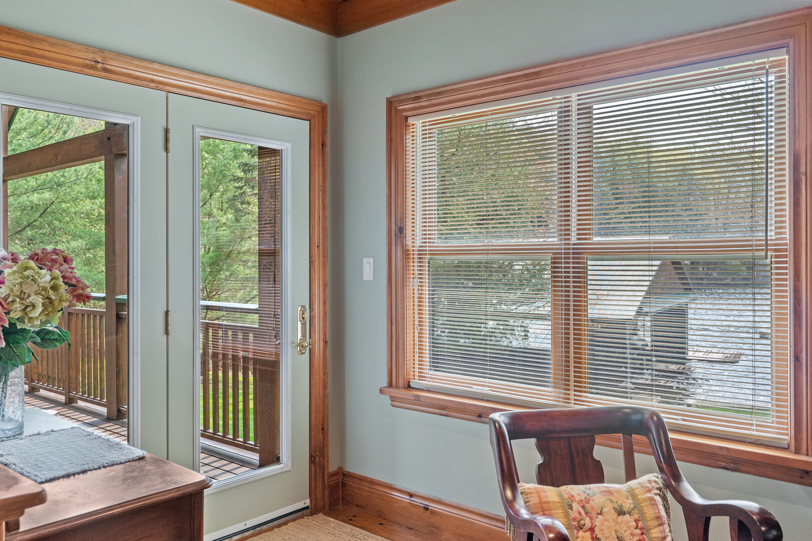 A door in a primary bedroom that leads out to a back deck.