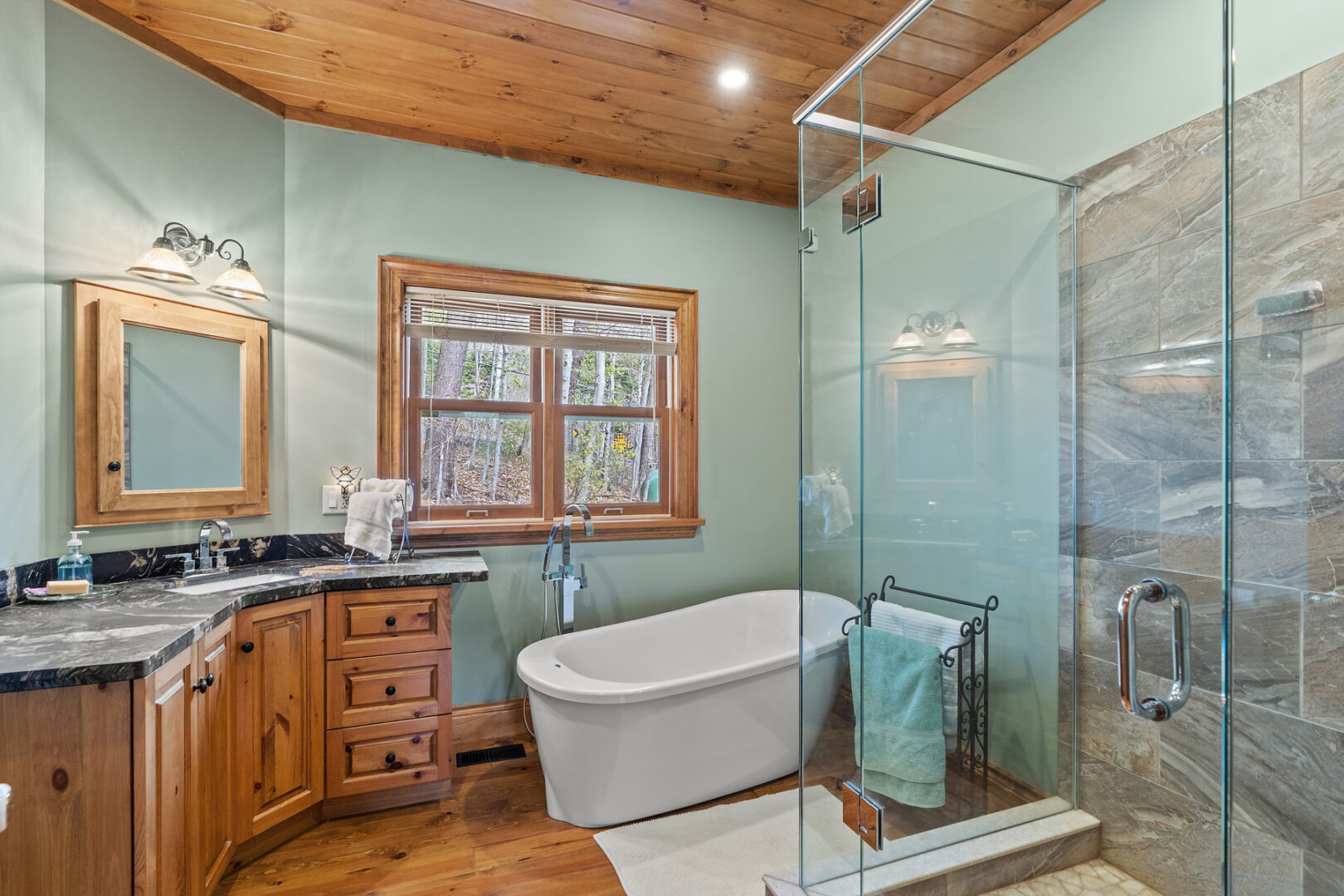 A large ensuite bathroom with a bathtub and a walk-in shower.