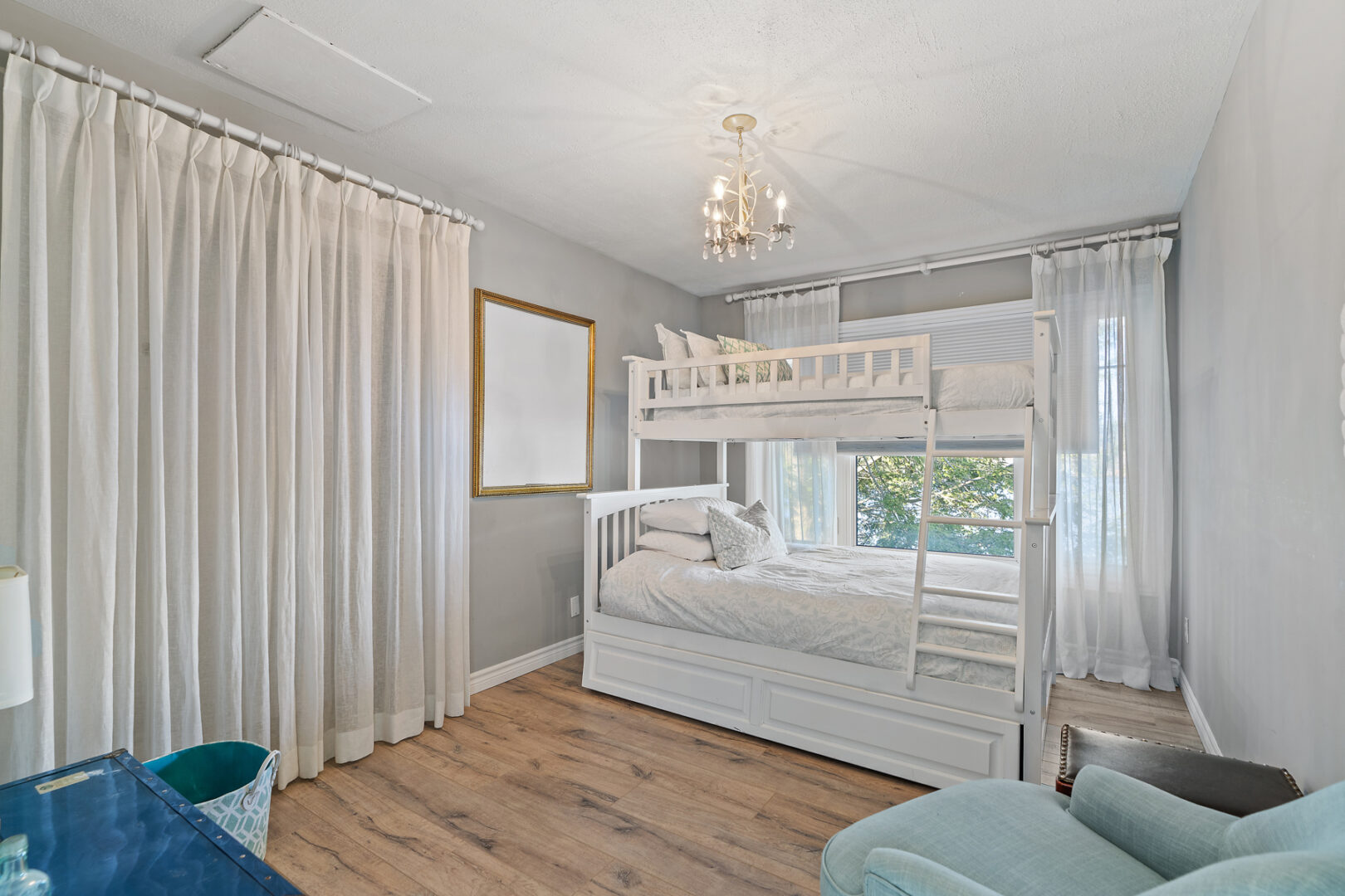 A bright room with bunkbeds and a window.