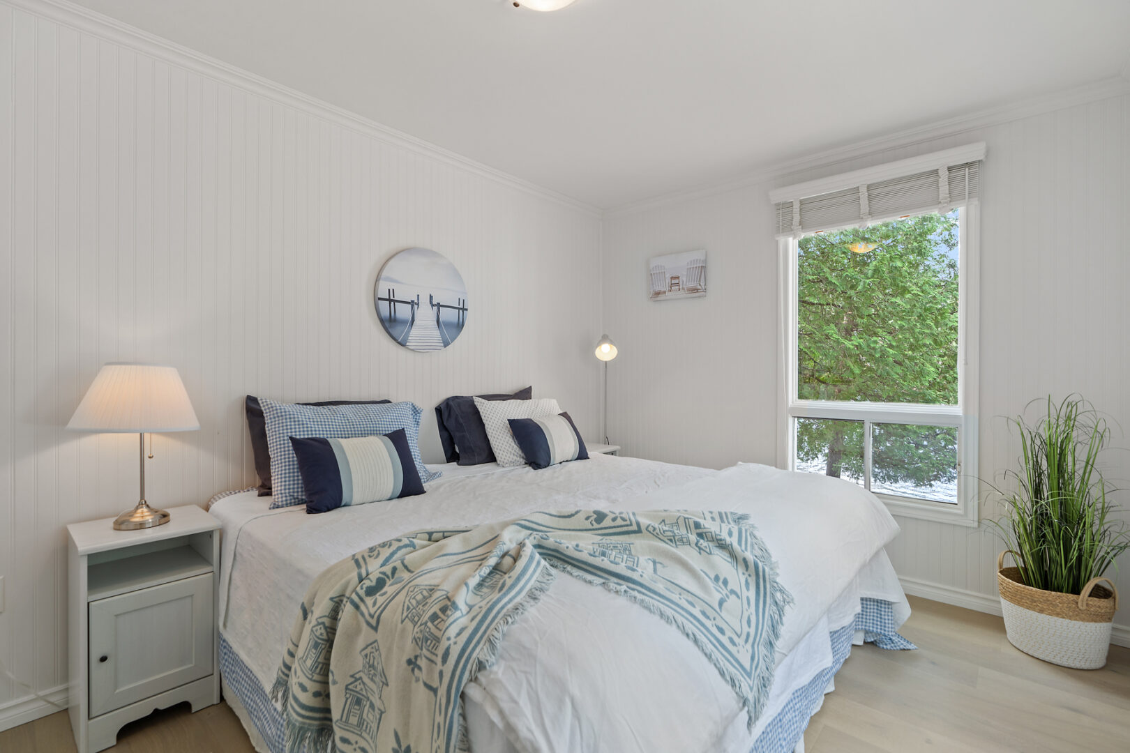 A bright bedroom with large windows and a big bed.
