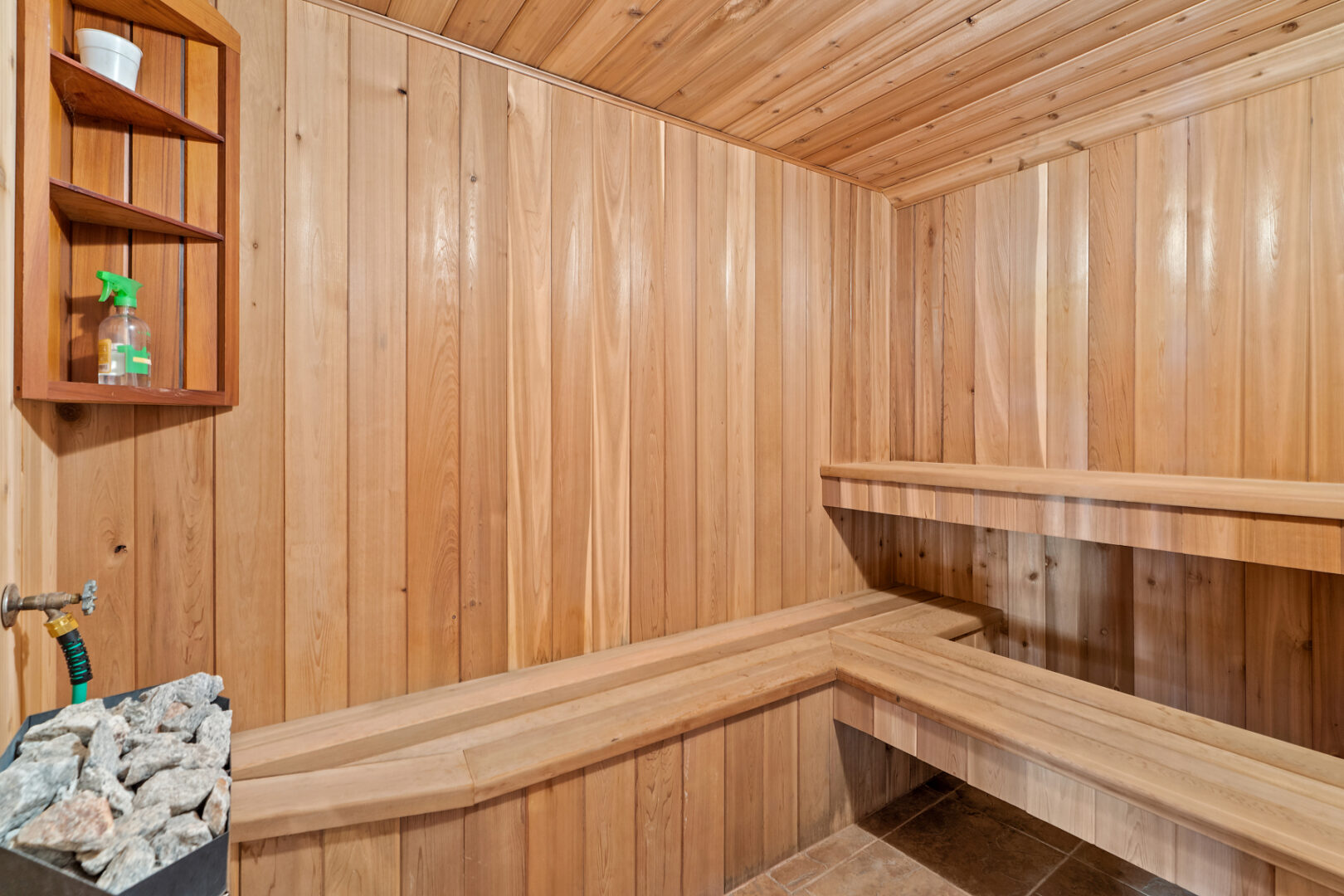 A wood sauna with lots of seating.