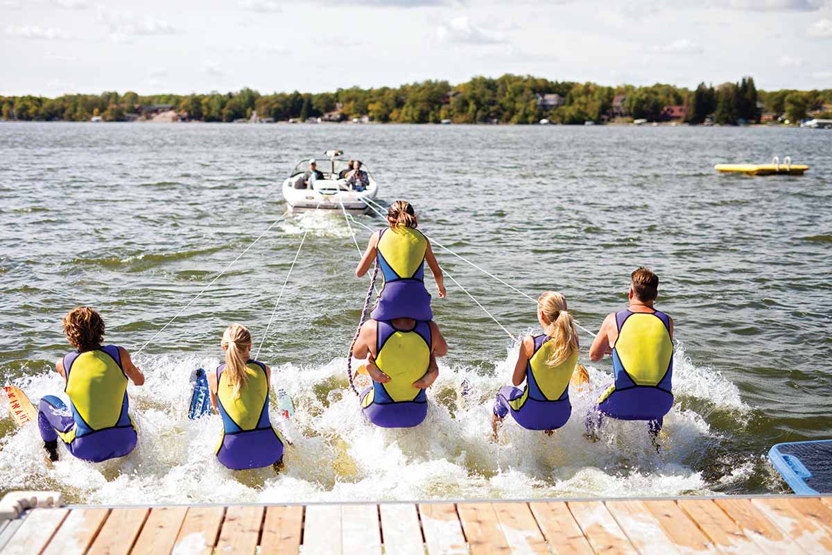 Club de Skinautique members practicing a pyramid formation on Lake Metigoshe.