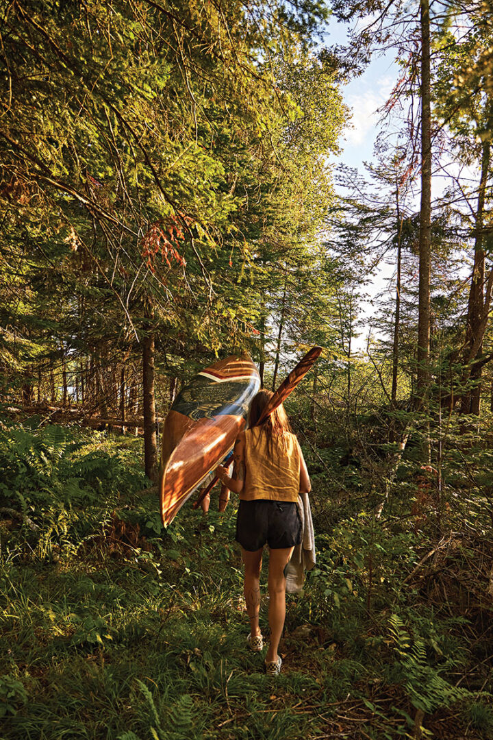 The couple carry their fibreglass canoe to the water