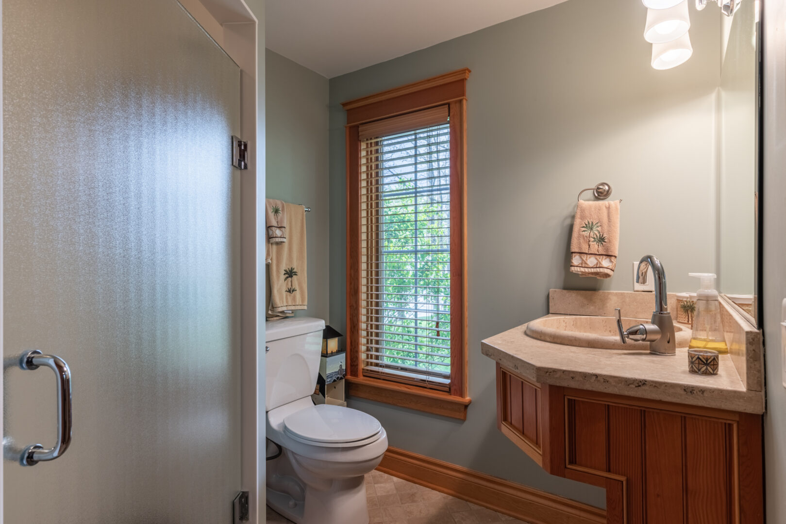 A large bathroom with a toilet, a sink, and a walk-in shower.