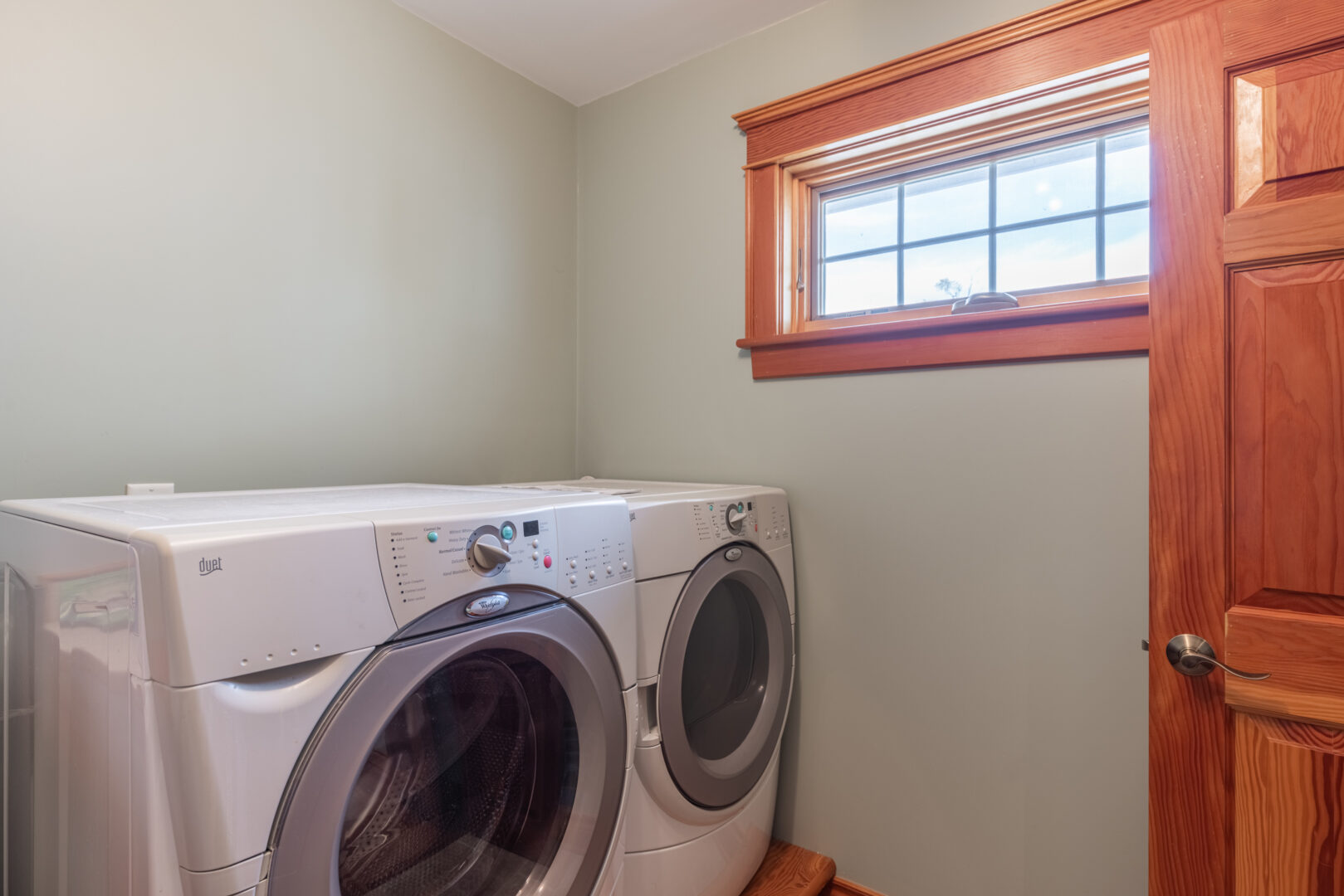 A small room with a washing machine and a dryer.