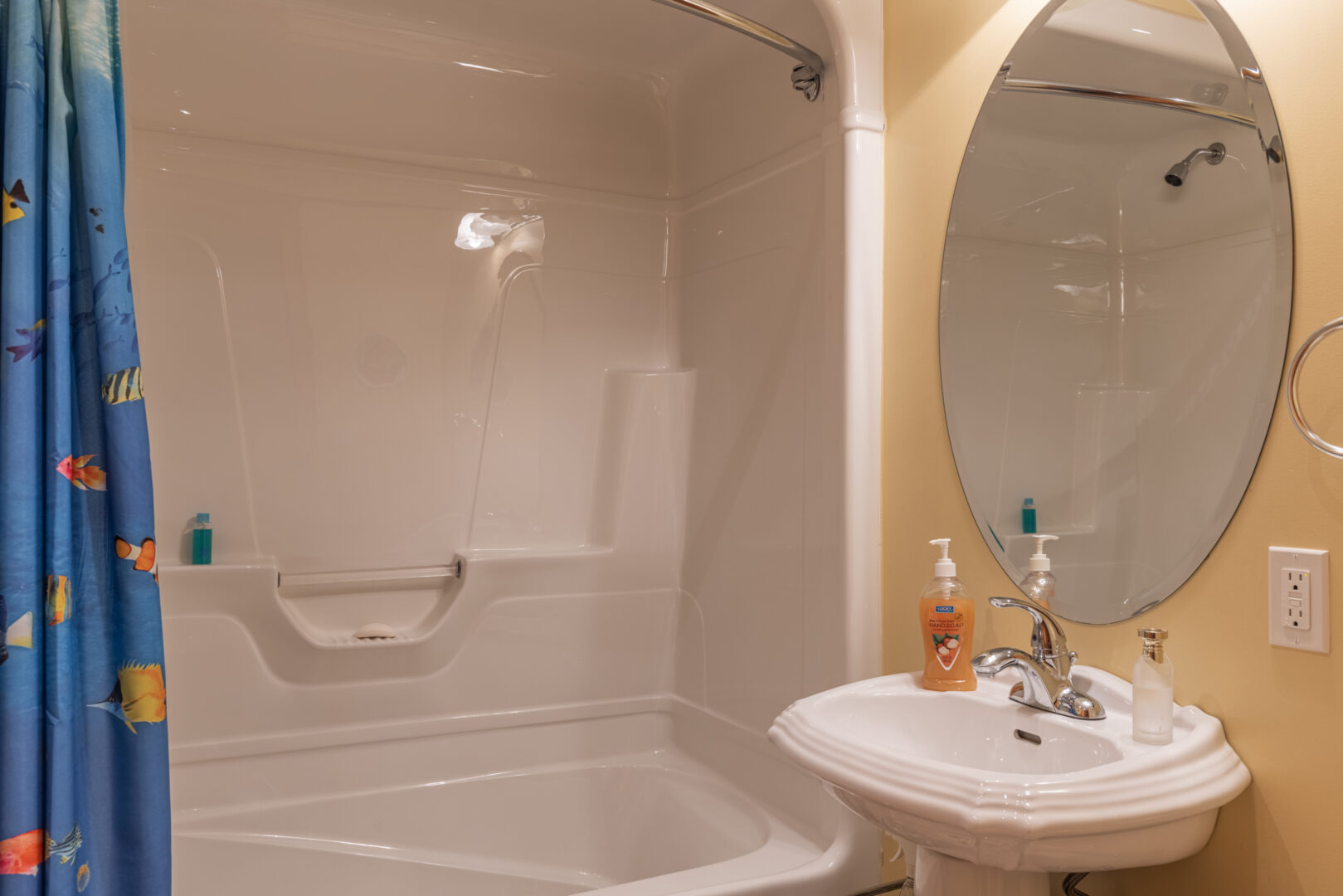 A small bathroom with a sink and a shower/tub combo.