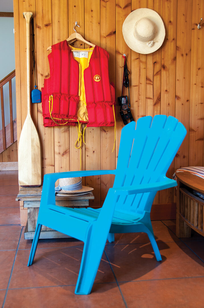 muskoka chair, lifejacket, paddle, and at sit inside the cottage