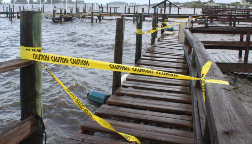caution tape cordons off a dock