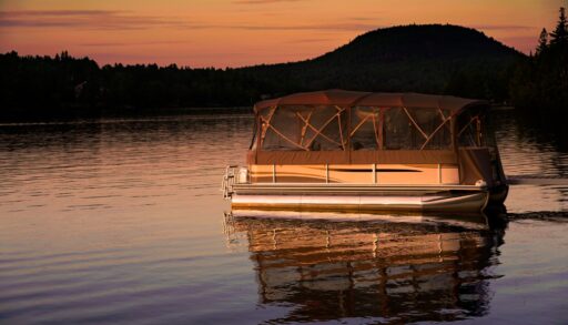 Pontoon boat on the lake at sunset