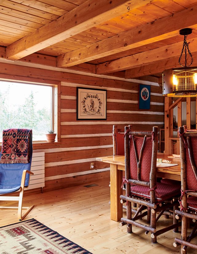 view of kitchen and living room with log walls