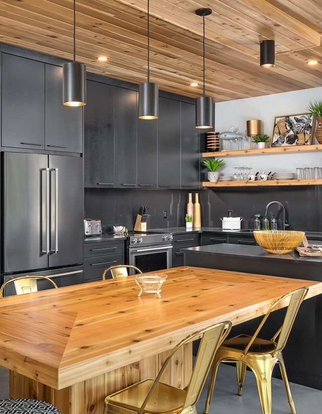 kitchen with wooden table and black sleek cabinets