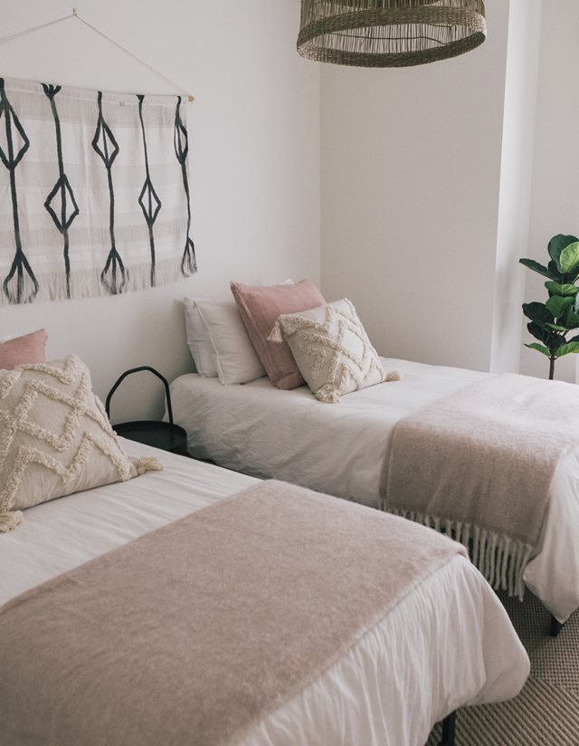 twin beds with beige bed sheets