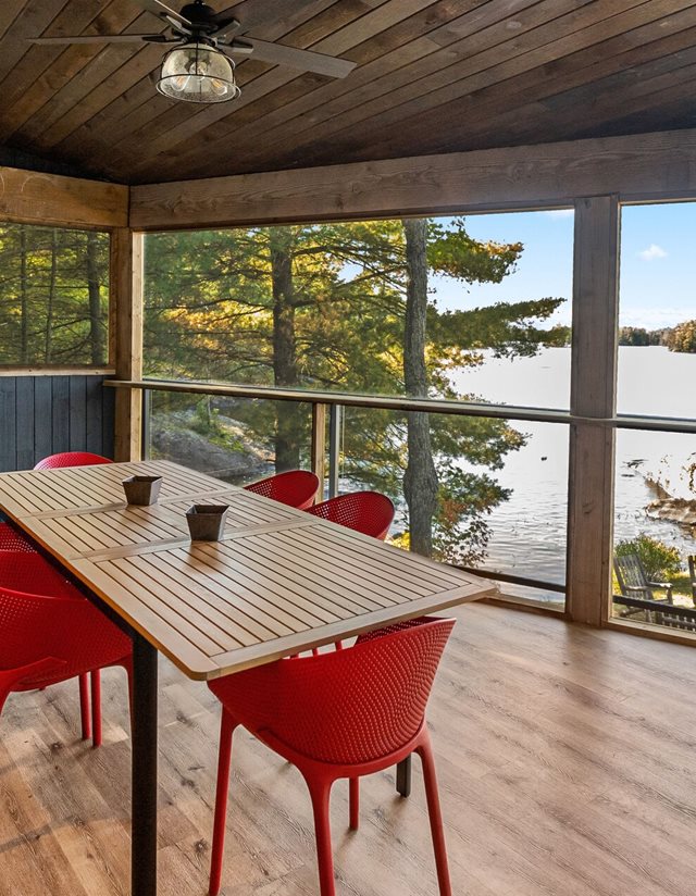 dining room with window views of the lake and red dining chairs