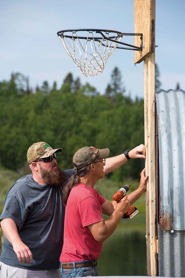 David installing a basketball net