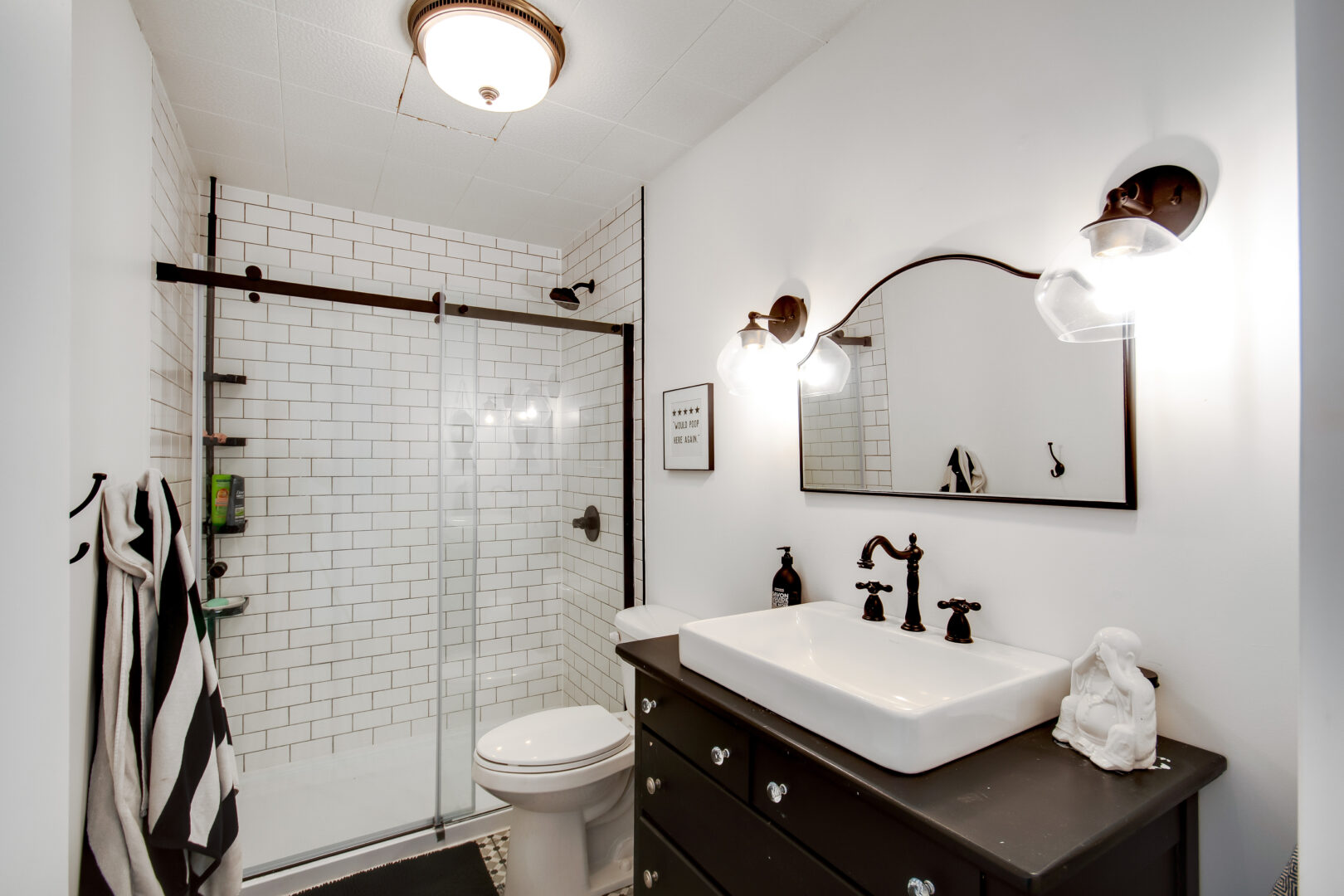 A big, modern bathroom with a walk-in shower, a toilet, and a sink.