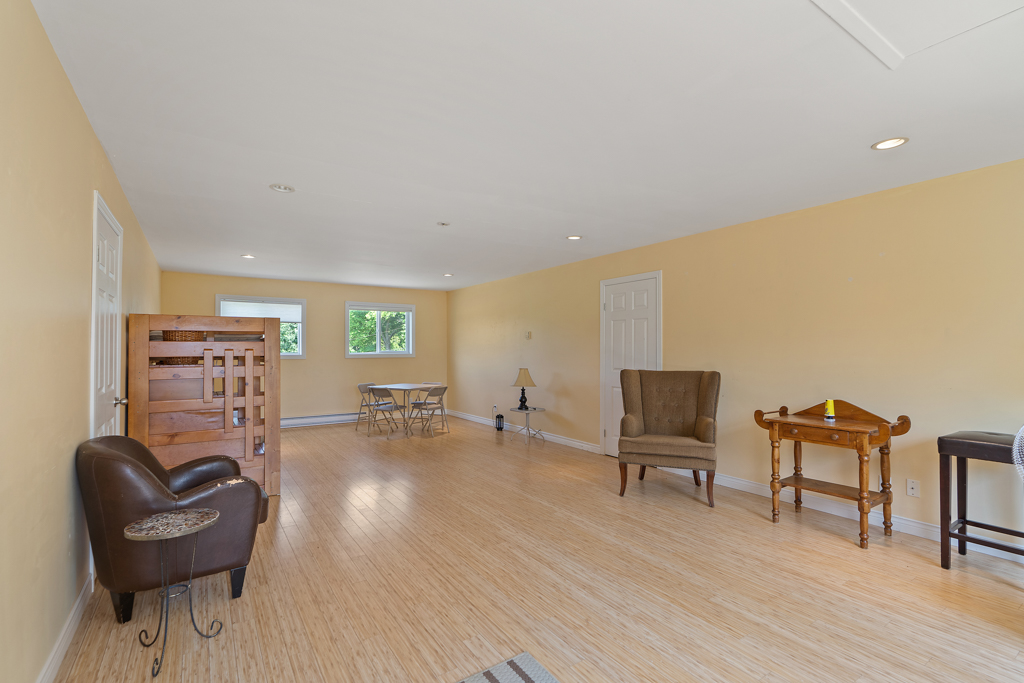 Interior of second-floor loft space in a detached garage. The space is bright and has hardwood floors and a bunkbed.