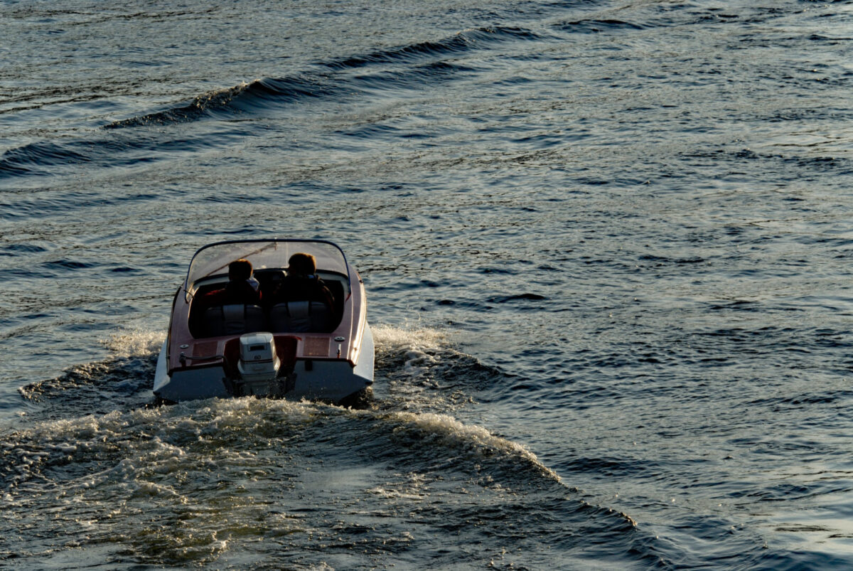 Small motor boat driving away